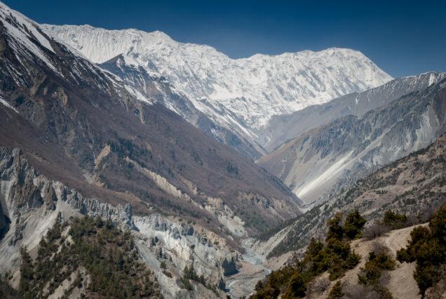 The majestic mountains of Nepal. River in deep gorges against the background of snow peaks
